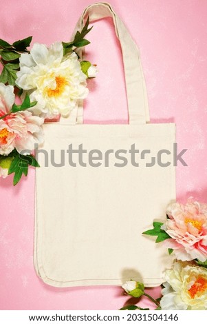 Wedding and bridal party, Mother's Day or Spring theme tote bag SVG craft product flat lay mockup. Tote Bag with peony flowers on pink background.