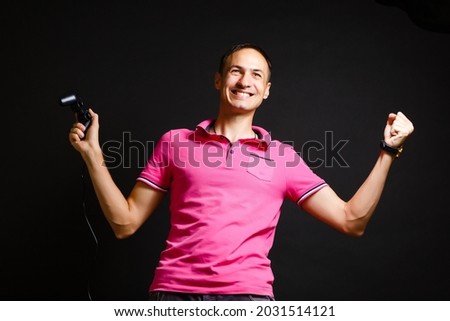 a man plays with a joystick at home on a black background