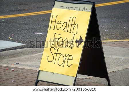Health food store sign with arrow