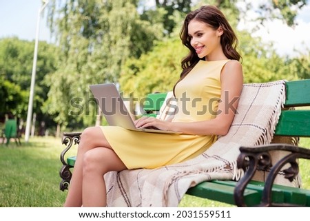 Profile side photo of young attractive girl happy positive smile chat type laptop education study outdoors