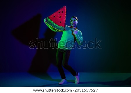 Full body photo of young cheerful man happy positive smile hold big watermelon slice isolated over dark color background