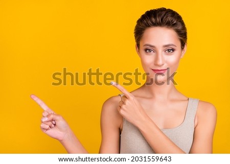 Photo of reliable pretty lady indicate fingers empty space sale banner wear grey top isolated yellow color background