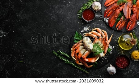 Set of crustaceans. Boiled crab claws and lobster. Rustic style. Seafood delicacies. Royalty-Free Stock Photo #2031609032