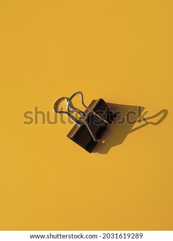 a document clip on a yellow background