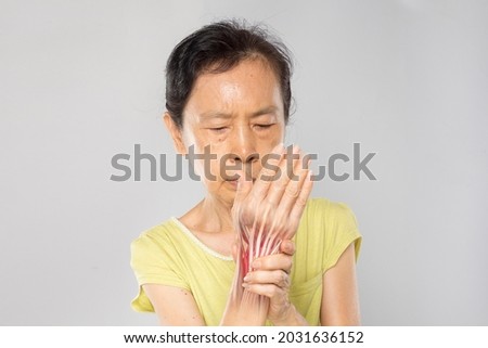 old asian woman feel wrist muscle pain