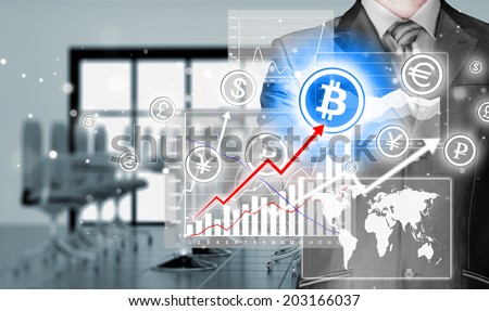 Choosing bitcoins, businessman pressing touch screen button.