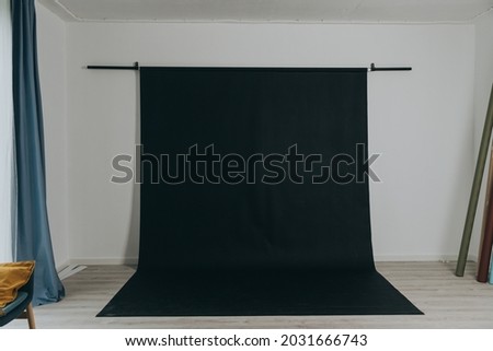 Black vinyl backdrop on mount in photo studio, studio equipment