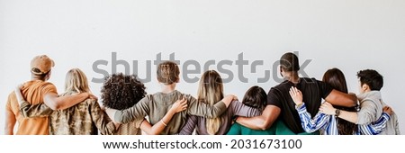 Rearview of diverse people hugging each other