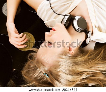 Young attractive blonde girl listening music