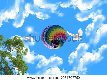 Colorful hot air balloons in the blue sky. green tree branches. flying white dove. bottom view stretch ceiling sky picture.