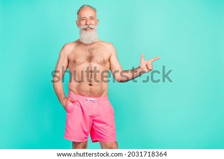 Photo of retired promoter man indicate forefinger empty space wear pink shorts isolated teal color background