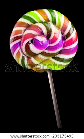 Bright colorful lollipop over black background isolated