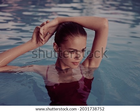 pretty woman swimsuit in the pool close-up cosmetics