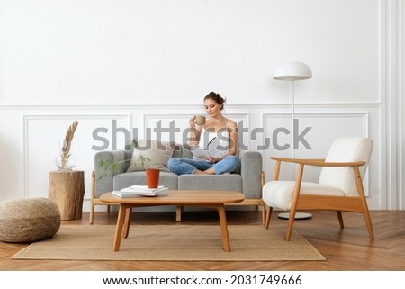 Woman relaxing in a minimal home Royalty-Free Stock Photo #2031749666