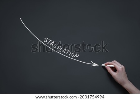 crisis infographics, hand draws a graph of stagflation in chalk on a blackboard, stagnating economy with high inflation rates, depreciation of money, Royalty-Free Stock Photo #2031754994