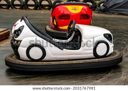 White and red bumper cars at the amusement park. Fairground with attractions. Colorful dodgems. Royalty-Free Stock Photo #2031767981