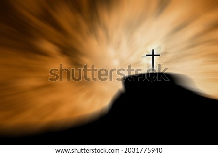A cross on a hill with vivid sky. 