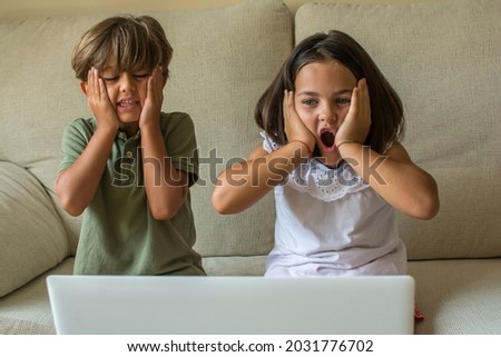 Children At home.
Stock Photo Of A Boy And A Girl At Home Watching A Movie Or Series On The Computer. They Have Fun And Have Fun Skills.