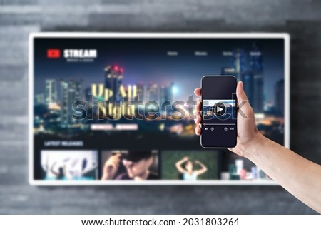 Movie stream with tv and phone. Watching on demand (VOD) series mockup with smart television and cellphone. Man using remote control video player app in smartphone. Streaming service subscription.