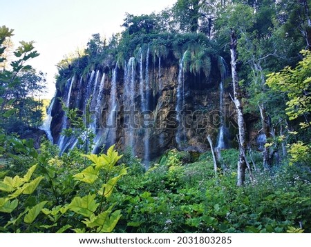 Waterfall in Upper lakes Region of Plitvice Lakes National Park in shady blurry evening light in the Summer