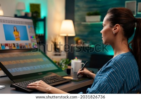 Photo editing expert retouching background on photo image for lights and gradient using digital tablet and stylus. Graphic design specialist woman working on template virtual project