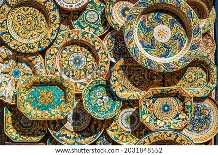 Erice, Sicily. Colorful hand-decorated ceramics. Traditional tourist suvenir,hand made crafts.Plates with ornamental floral decoration.Summer vacation in Italy,travel art scene. Royalty-Free Stock Photo #2031848552