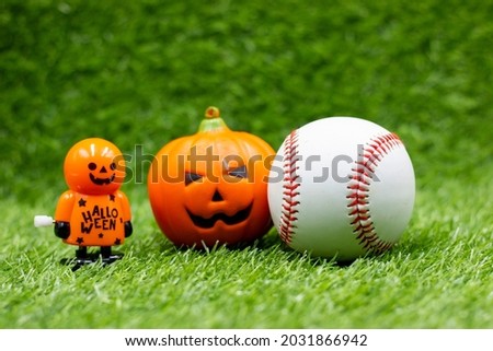 Baseball is on green grass for Halloween Day 