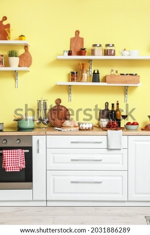 Cooking utensils and products on table in interior of modern kitchen