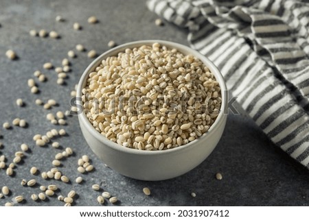 Raw Organic Dry Pearl Barley in a Bowl Royalty-Free Stock Photo #2031907412