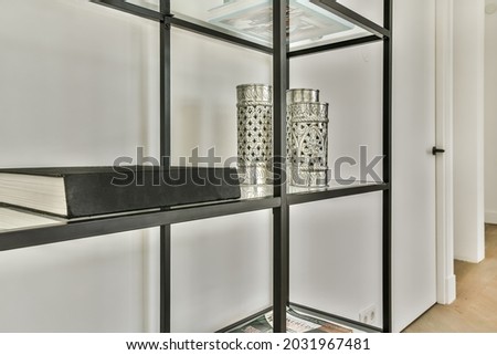 Minimalistic metallic furniture with decorative elements and book. High quality photo