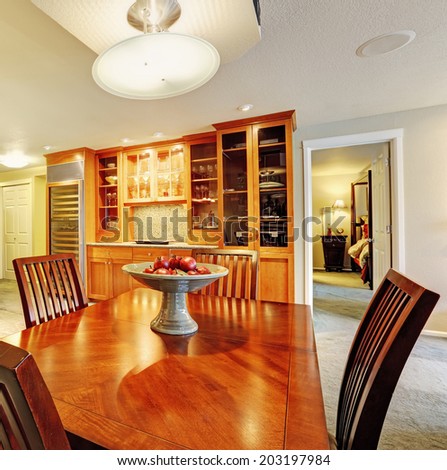 Spacious dining room with dining table and storage cabinets