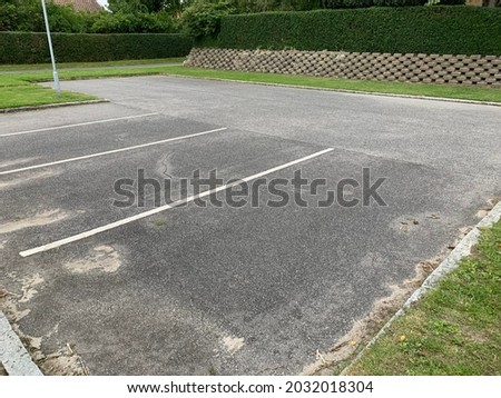 parking lot in a suburban neighborhood with 4 parking lots spaces on black asphalt