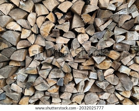 stacks of timber wood in back of garden, wooden pieces stacked after being chopped for big fire, bonfire material