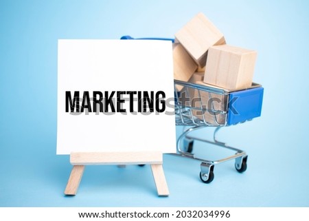 Shopping cart and easel with a marketing sign. Sale concept