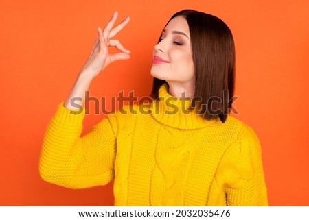 Profile side photo of young woman happy positive smile show perfect gourmet delicious sign isolated over orange color background Royalty-Free Stock Photo #2032035476