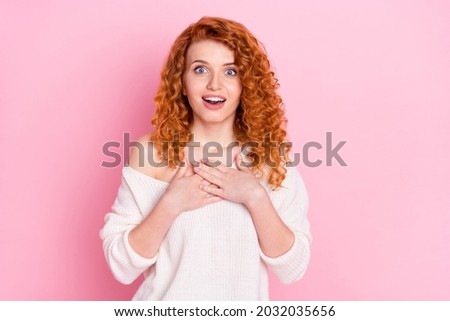 Photo portrait of curly girl amazed staring keeping hands on chest isolated pastel pink color background