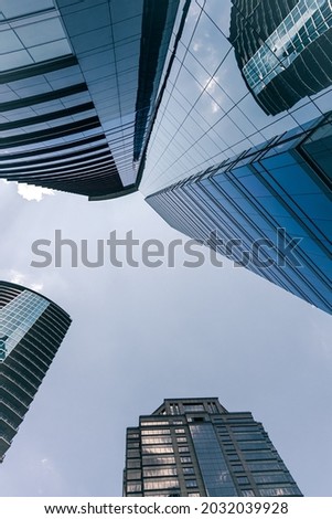 Glass skyscrapers in the city. Looking up into the sky.