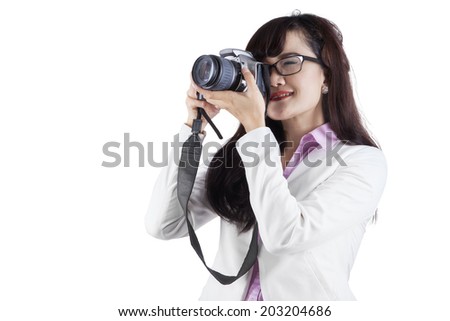 Woman with DSLR camera over white background