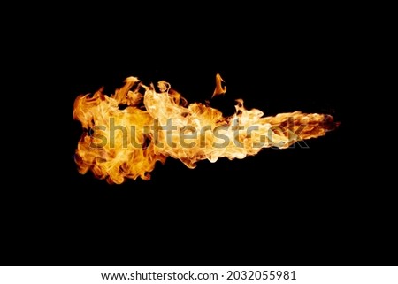 Fire flame jet stream on dark black background.