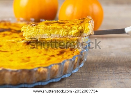 Fresh pumpkin pie. Pie on a brown wooden table. Copy space