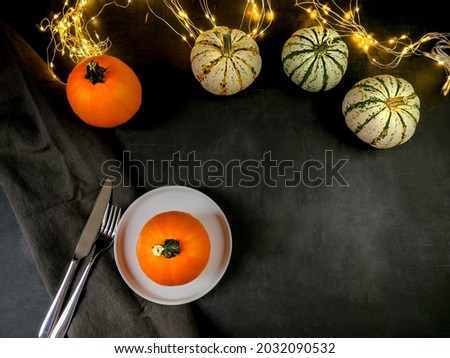 Thanksgiving Day. Festive table. Pumpkins and lighted lights. View from above