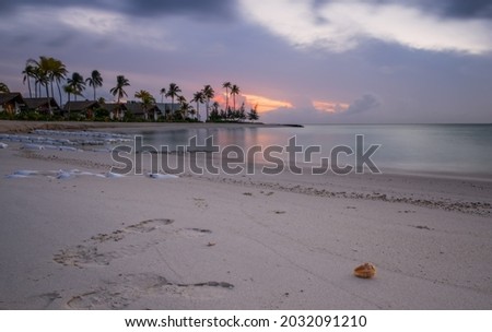 Beautiful vivid sunrise over beach with the villas in the Indian ocean, Maldives. Crossroads Maldives, july 2021. Long exposure picture