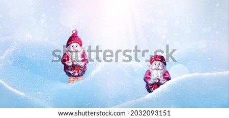 Christmas card. Santa Claus in snowdrifts in the rays of light. Winter snowy background. Wide format.