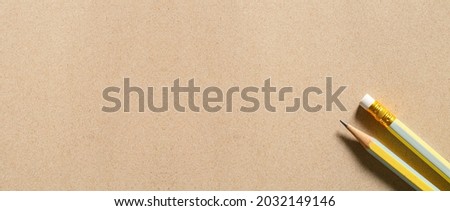 Macro pencil on brown paper surface,wood pattern pencil on brown paper background, top view.copy space for add text.background