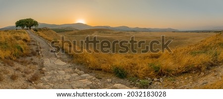 Panoramic sunset view of Hula Valley landscape with countryside and the Galilee mountains, viewed from Tel Hazor, Northern Israel