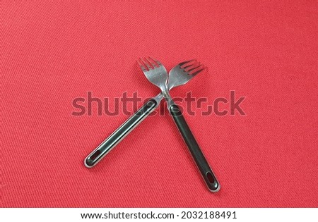 two fork isolated on the red table