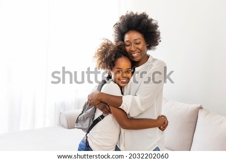 Getting ready for school. Shot of a mother getting her child ready for school. Mother sending off her elementary age Child to school during. Mom gets daughter ready for school in the morning