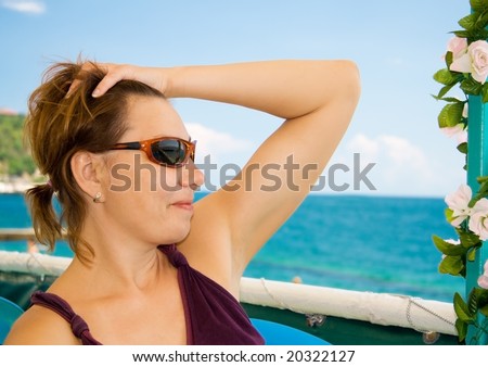 happiest woman in the sea resort against a backdrop of blue sky