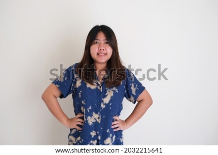 Angry Asian young women put her hands on waist Royalty-Free Stock Photo #2032215641