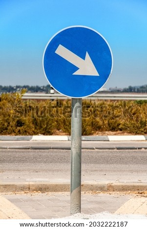 Arrow with a road sign. Street background.
